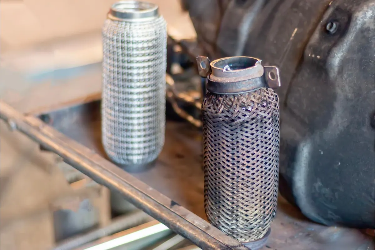 Two diesel particulate filter cores out of their housings showing clean and soot loaded substrate