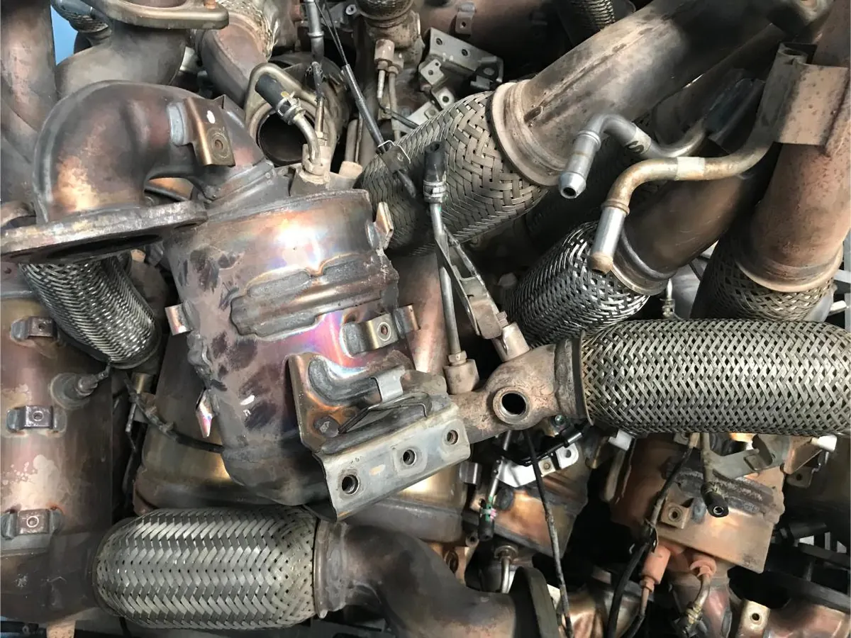 Diesel exhaust pipework and particulate filter assemblies removed from vehicles for servicing