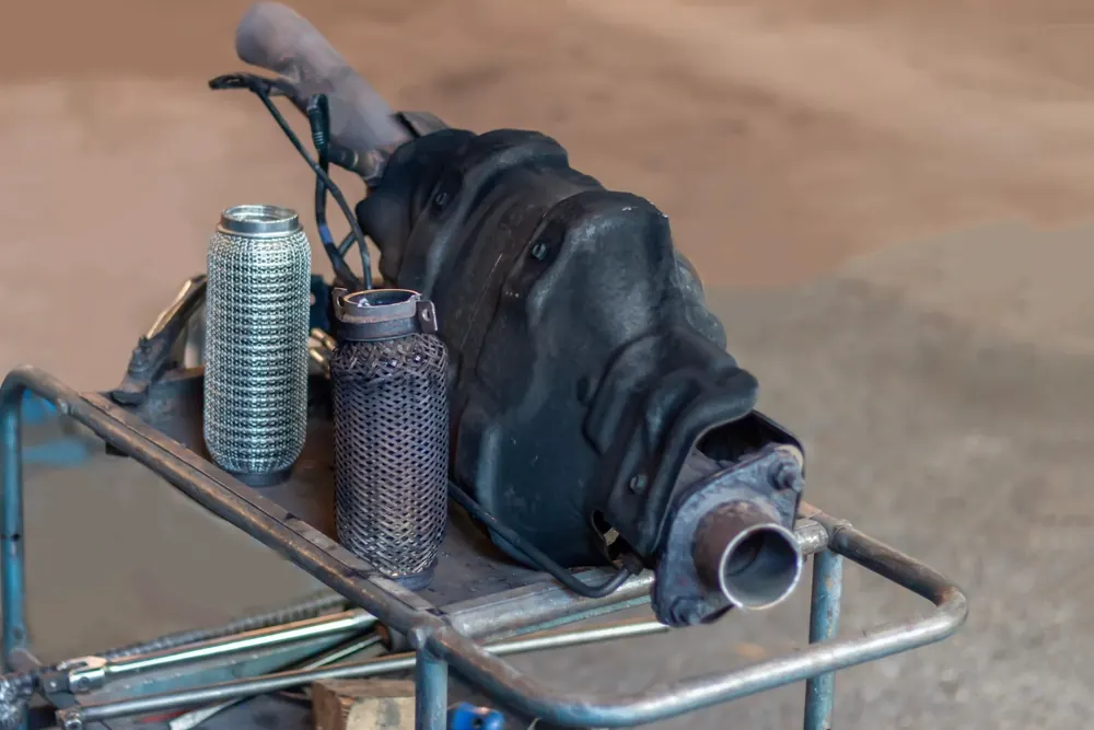 Diesel particulate filter and exhaust components on a workshop trolley during a clean